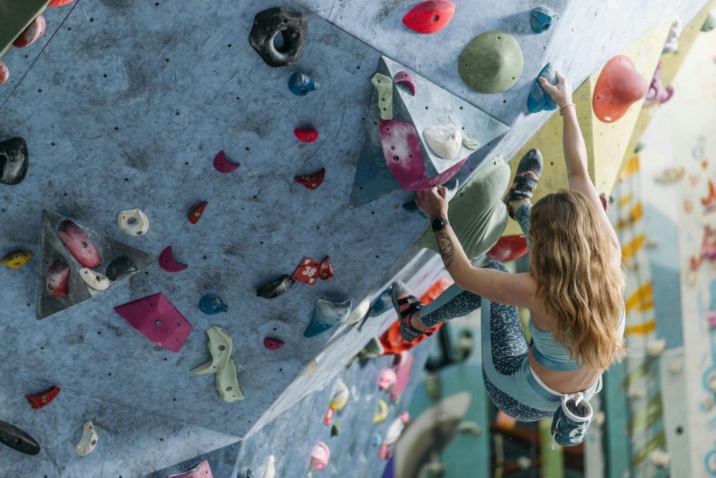 Frau an einer Boulderwand
